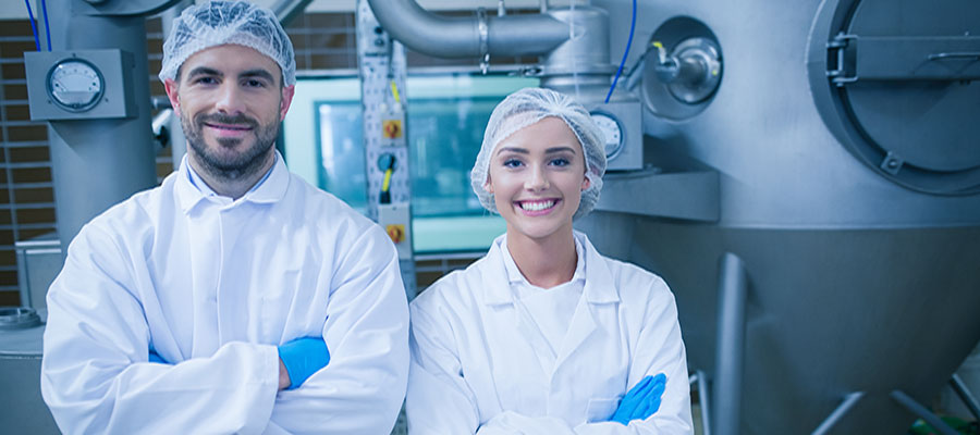 industrial food processing employees smiling